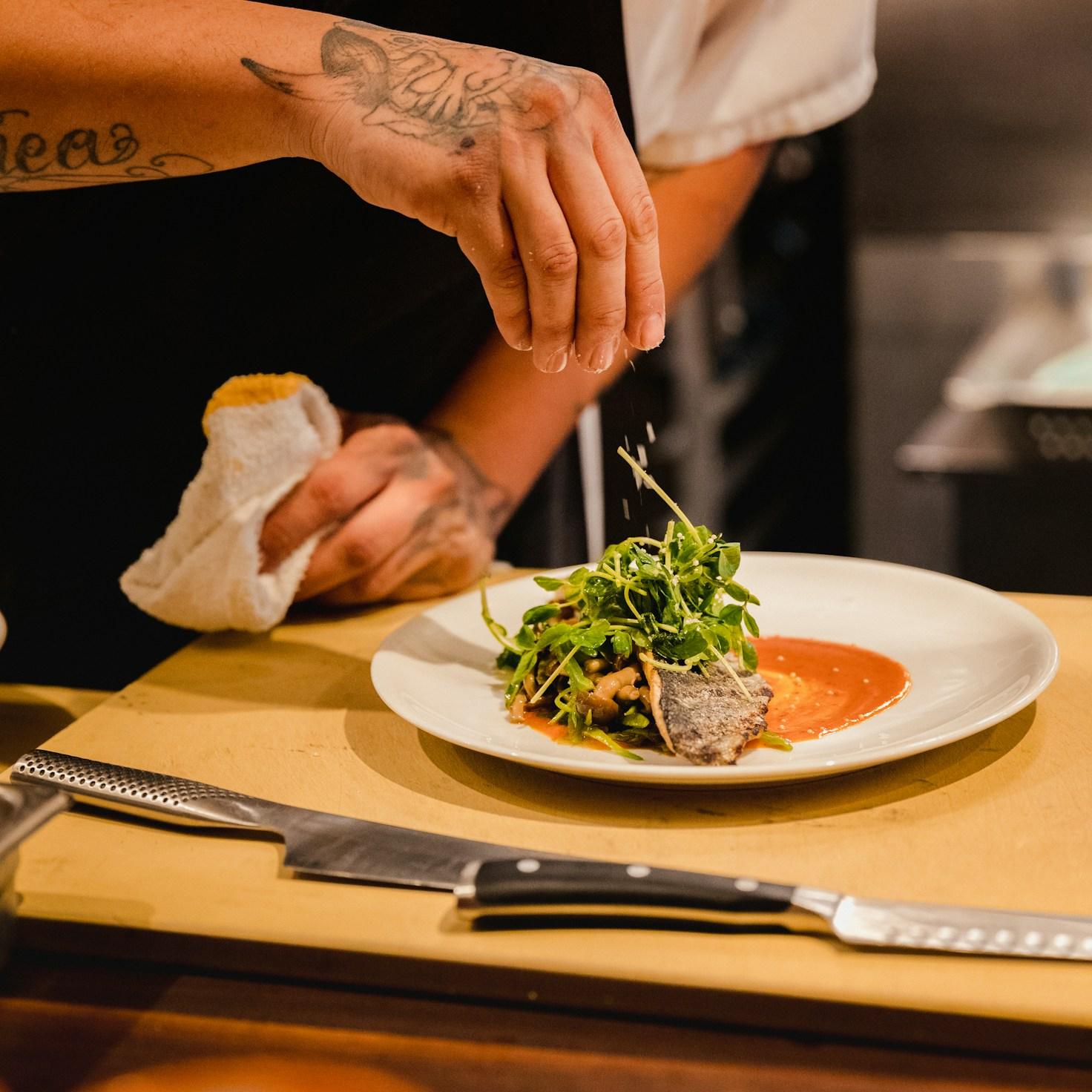 Community members collaborating in a modern kitchen space, sharing recipes and cooking techniques